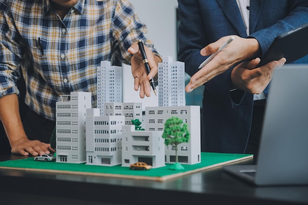 Real estate planning session with building mockup